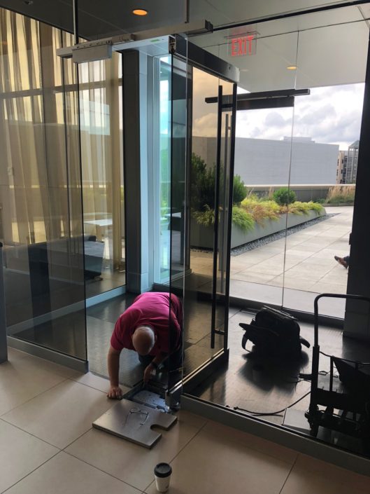 A person cleaning the outside of a building.